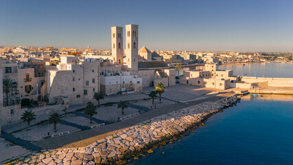 Aerial view old Mediterranean coastal city with big cathedral on sunny day, Molfetta, Puglia, Italy