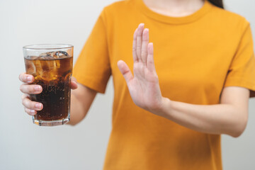 Diet, Dieting. Attractive asian young woman, girl push out cold cola, refuse carbonated soft drink...