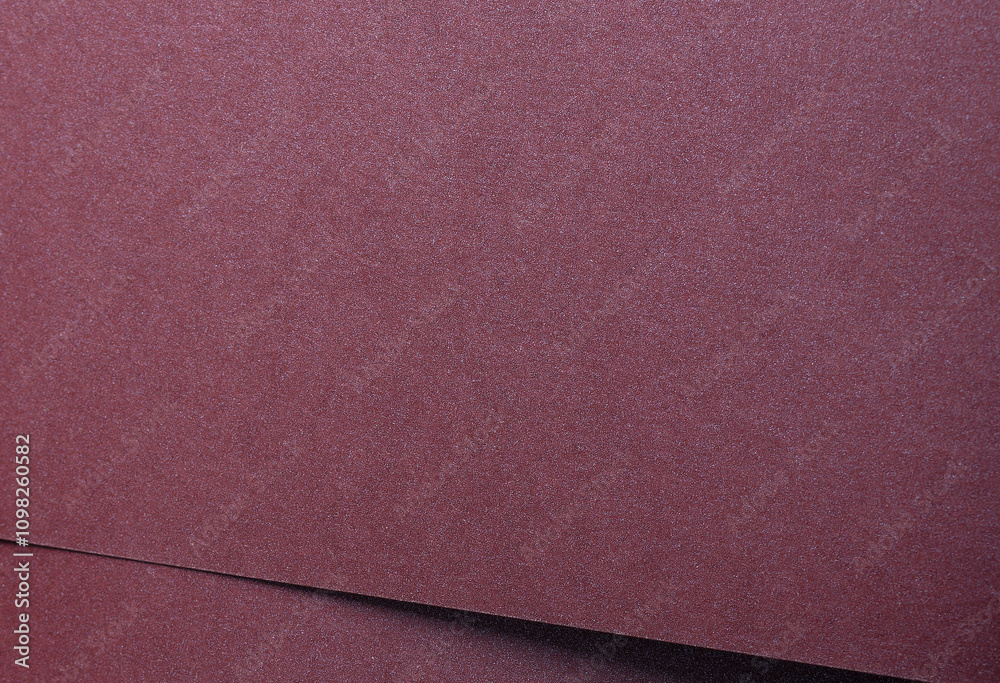 Aufkleber metallic burgundy paper background with smooth, shimmering layers and subtle folds. featuring deep, 