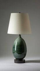 Elegant luxury lamp featuring black wooden base and jade ceramic body with a white shade