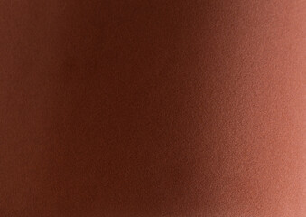 Fototapeta premium Terracotta velvet textured paper with a soft, matte surface. Elegant and luxurious design in a reddish brown monochrome tone. Perfect for modern, stylish backdrops, premium