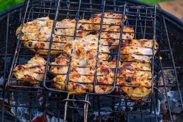 Marinated Chicken Breast Grilling on Charcoal BBQ with Perfect Char Marks. Juicy Grilled Chicken...