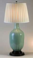 Elegant lamp design featuring black wooden base, jade ceramic body, and sophisticated white shade