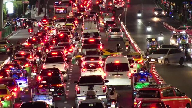 BANGKOK, THAILAND - AUGUST 2024 : 4K time lapse shot of traffic jam at night. Busy rush hour at downtown shopping area. Transportation and street traffic concept video.