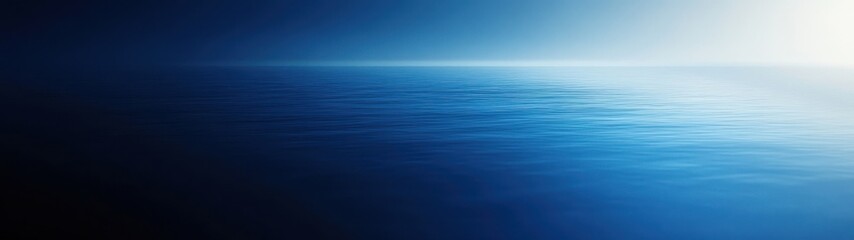 Fototapeta premium A serene ocean view with a gradient of blue hues and calm water surface.