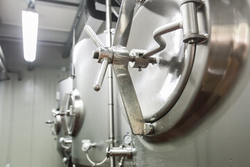 Stainless steel fermentation tanks in a modern brewery