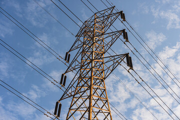 Power Lines. High-Voltage Electrical Tower. Transmission of Electricity. Metal High-voltage tower with high voltage wires and glass cups electro - insulators.

