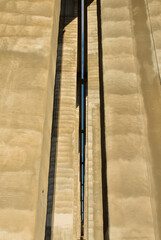 A towering, symmetrical concrete structure of a bridge extends skyward, showcasing architectural beauty in construction.