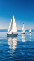 Fototapeta premium Sailing on calm waters with multiple sailboats under a clear blue sky