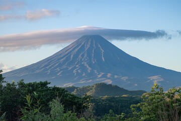 A majestic volcano with a conical shape, surrounded by lush greenery.
