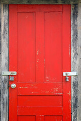 Weathered Red Door with Padlocks and Crackling Paint