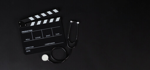 Clapper board or movie slate and stethoscope on black background..