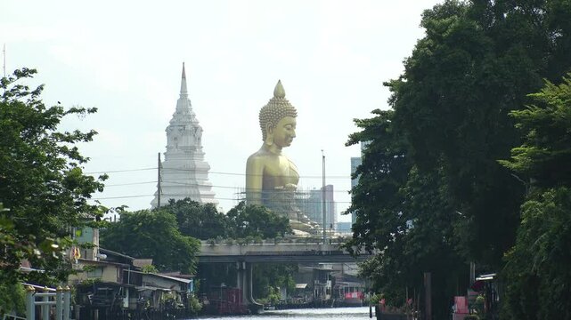 BANGKOK, THAILAND - AUGUST 2024 : View of Giant Golden Buddha at Wat Paknam. Royal temple located in Phasi Charoen district at the Bangkok Yai river.