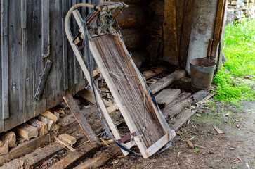 there is a wooden sleigh with a stretched rope. Wooden large sleigh for transportation.