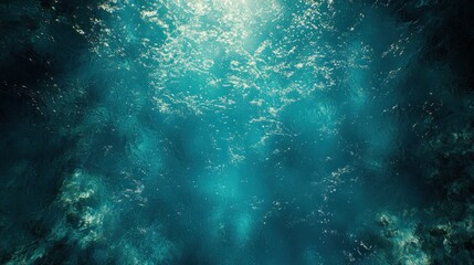 Fototapeta premium Underwater sunbeams pierce the dark blue ocean.