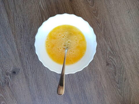 beaten eggs in a plate, yellow
