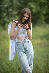 Young beautiful girl in a summer park in nature.