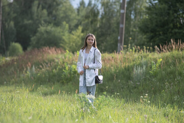 Fototapeta premium Young beautiful girl in a summer park in nature.