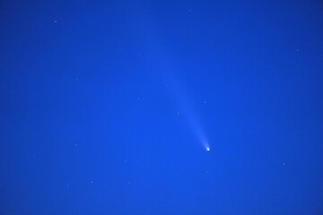 Comet C 2023 A3 Tsuchinshan ATLAS streaks across a starry blue twilight sky in October 2024