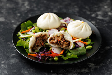 Steamed Teriyaki chicken and vegetable bao buns served with Asian style salad