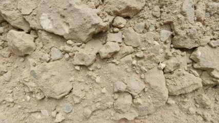 A close-up shot of a rough and rugged stony texture, textured, surface