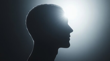 Obraz premium A man's head is shown in a silhouette against a dark background