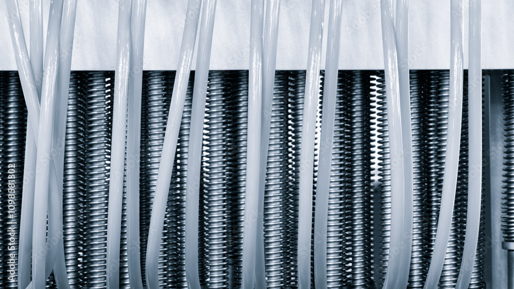 Aufkleber dairy machine cooling radiator with a row of stainless steel metal pipes with silver trim. the pipes