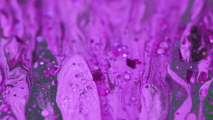Paint drip. Glitter fluid flow. Defocused purple color shimmering sequin grain particles oil drops...
