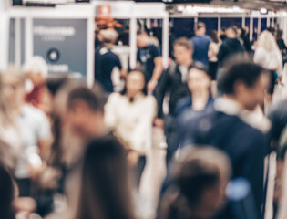 Abstract blurred people at exhibition hall of expo event trade show. Business convention show or...