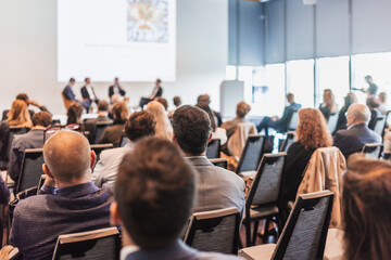 Obraz premium Interview and round table discussion at business convention and presentation. Audience at the conference hall. Business and entrepreneurship symposium.