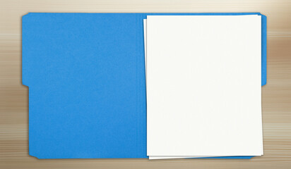 open folder on wood table, blank papers
