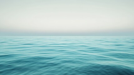 Obraz premium A calm ocean with a clear blue sky in the background