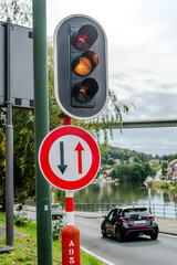 Traffic spotlight with Charlemagne bridge in the background in Dinant, Belgium