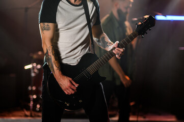 Fototapeta premium Guitarist playing electric guitar during live rock concert on stage