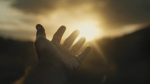 Silhouette of prayer human hand open palm up worship in the morning with sunrise sky. Freedom and spirituality concept. God helping repent catholic easter lent mind pray. Christian religion, belief