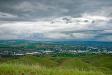 Obraz premium photo of the Lewiston Valley and Clearwater River taken from the Lewiston Hill with spring storm clouds in the background