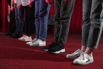 Professional actors bowing on stage in theatre, closeup