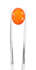 Tweezers with shiny orange gemstone isolated on white