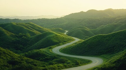 Fototapeta premium A winding road meanders through lush green hills, framed by a soft pastel sky at dusk, inviting serene exploration and a sense of tranquility in nature's embrace