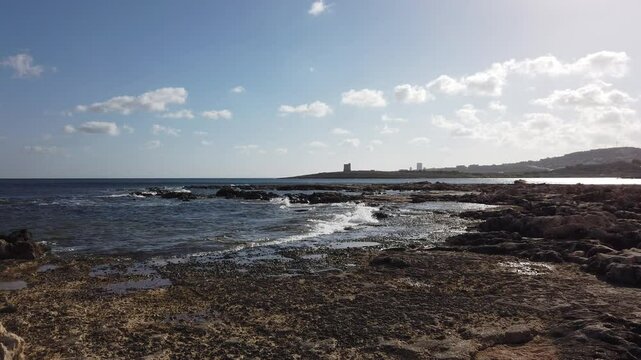 Rocky coast of Malta and Ghallis Tower, Salina small watch tower in the back. Second of De redis Towers. High quality 4k footage