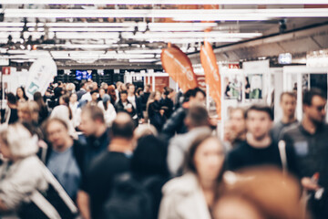 Abstract blurred people at exhibition hall of expo event trade show. Business convention show or...