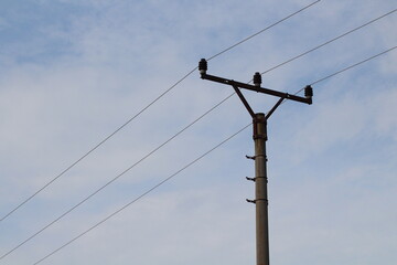 Railway train cables and electricity on a beautiful blue sky background. Electric lines over the train tracks
