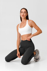 Fototapeta premium Fitness woman. Athletic girl on the gray background