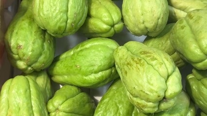 Fototapeta premium A Beautiful Collection of Fresh Chayote Vegetables Piled Together in a Delightful Manner