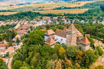 Obraz premium Viscri, Romania. Blue old painted traditional house from village, Transylvania. The Viscri fortified church