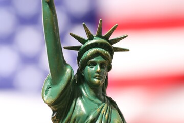 Statue of Liberty against flag of USA, closeup