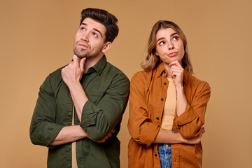 A Pensive Couple Deep in Reflective Thought Against a Calm, Neutral Background Setting
