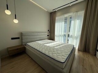 Modern bedroom interior with natural light and contemporary lighting fixtures