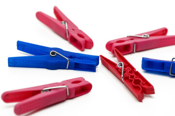 Colorful clothespins scattered on a white surface creating a vibrant arrangement for everyday use