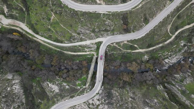 Aerial drone view of winding hairpin roads on the M-618 road towards Colmenar Viejo near Madrid, Spain offering stunning views of the surrounding countryside